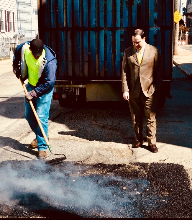Mayor Flanagan on the street with a Fall River public works crew filling potholes