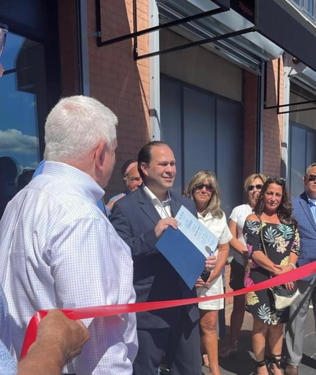 Will Flanagan cuts the ribbon at a new Fall River business opening